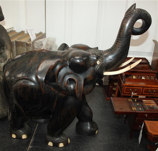 A large Indian ebonised carved hardwood elephant, 21in.